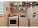 Laundry area with washer, dryer, and shelving at 26387 Madagascar Rd, Punta Gorda, FL 33983