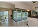 Living room with sliding glass doors offering scenic pool and lake views at 26387 Madagascar Rd, Punta Gorda, FL 33983