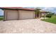 The home's paved driveway and attached three-car garage at 26387 Madagascar Rd, Punta Gorda, FL 33983