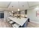 Modern kitchen featuring gray cabinets, a large island and pendant lights at 276 Lewis Cir # 112, Punta Gorda, FL 33950