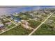 Single-Gathering home on a waterfront lot, view of surrounding homes at 2877 Howe Rd, Port Charlotte, FL 33981
