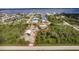 Aerial view showcasing a house, garage, and large lot near the water at 2877 Howe Rd, Port Charlotte, FL 33981