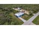Aerial view of house, detached garage, and spacious lot at 2877 Howe Rd, Port Charlotte, FL 33981