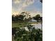 Back patio and small landscaped yard with mulch beds at 2877 Howe Rd, Port Charlotte, FL 33981