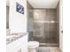 Bathroom with granite countertop, white cabinets, and a large walk-in shower at 2877 Howe Rd, Port Charlotte, FL 33981