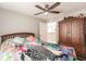 Bedroom with ceiling fan and colorful bedding at 2877 Howe Rd, Port Charlotte, FL 33981