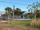 Rear view of a gray single-story home with a patio and lawn at 2877 Howe Rd, Port Charlotte, FL 33981