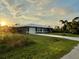 Charming one-story home with a well-maintained lawn and a concrete driveway at 2877 Howe Rd, Port Charlotte, FL 33981