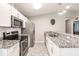 Updated kitchen featuring stainless steel appliances and granite countertops at 2877 Howe Rd, Port Charlotte, FL 33981