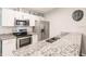 Modern kitchen with stainless steel appliances and granite countertops at 2877 Howe Rd, Port Charlotte, FL 33981