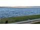 Scenic view of a lake with grassy shore and guard rail at 2877 Howe Rd, Port Charlotte, FL 33981