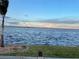 Serene waterfront view with calm waters under a partly cloudy sky at 2877 Howe Rd, Port Charlotte, FL 33981
