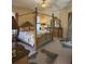 Main bedroom featuring carpeted floors, four-poster bed, matching furniture set, and lanai access at 3100 Sheboygan Ave, North Port, FL 34286