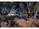 Spacious backyard with large trees, wooden benches, and a fenced area at 3262 Steadman St, Punta Gorda, FL 33980