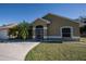 Tan house with palm trees and a security door at 3262 Steadman St, Punta Gorda, FL 33980