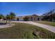 Tan house with palm trees and a long driveway at 3262 Steadman St, Punta Gorda, FL 33980