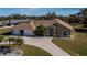 Tan house with palm trees and a large driveway at 3262 Steadman St, Punta Gorda, FL 33980