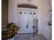 Inviting front entrance with double white doors, wrought iron gate, and lush potted plant at 3262 Steadman St, Punta Gorda, FL 33980