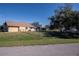 Tan house exterior with a fenced yard and lush green landscaping at 3262 Steadman St, Punta Gorda, FL 33980