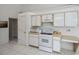 White kitchen with an electric range, microwave, and built-in cabinetry at 3262 Steadman St, Punta Gorda, FL 33980