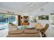 Spacious living room with pool view, comfortable seating, and large-screen TV at 3262 Steadman St, Punta Gorda, FL 33980