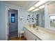 Bathroom with dual sinks, a large mirror, and a window at 368 Catamaran Ct, North Port, FL 34287