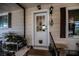 Exterior view of home's entry door with pet door and landscaping at 368 Catamaran Ct, North Port, FL 34287