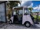 Beige golf cart with tan top parked in driveway at 368 Catamaran Ct, North Port, FL 34287