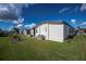 Light beige home with AC unit and small garden at 368 Catamaran Ct, North Port, FL 34287