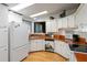 White kitchen with an orange countertop and appliances at 368 Catamaran Ct, North Port, FL 34287