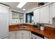 U-shaped kitchen with orange countertops and white cabinets at 368 Catamaran Ct, North Port, FL 34287