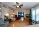 Living room with comfy seating, a Christmas tree, and wood floors at 368 Catamaran Ct, North Port, FL 34287
