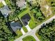 Modern home with a dark roof, driveway, and a view of surrounding properties from above at 4301 Marcella Ter, North Port, FL 34286