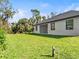 Spacious backyard with lush green lawn and landscaping at 4301 Marcella Ter, North Port, FL 34286