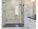 Walk-in shower with marble tile and black fixtures in a contemporary bathroom at 4301 Marcella Ter, North Port, FL 34286