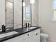 Modern bathroom with dark countertop, marble-look tile, and double vanity at 4301 Marcella Ter, North Port, FL 34286