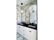 Luxurious bathroom boasts a double vanity, marble walls, and gold-framed mirrors at 4301 Marcella Ter, North Port, FL 34286