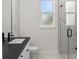 Modern bathroom with glass shower, single vanity, and marble tile at 4301 Marcella Ter, North Port, FL 34286