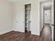 Bedroom featuring built-in shelving in closet and wood-look floors at 4301 Marcella Ter, North Port, FL 34286