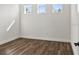 Bright bedroom with wood-look flooring and three large windows at 4301 Marcella Ter, North Port, FL 34286