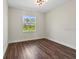 Bright bedroom with wood-look flooring and large window at 4301 Marcella Ter, North Port, FL 34286