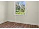Bright bedroom with a large window and wood-look flooring at 4301 Marcella Ter, North Port, FL 34286