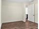 Empty bedroom with dark wood-like floors and a glimpse of a modern bathroom at 4301 Marcella Ter, North Port, FL 34286