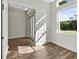 Bright bedroom with wood-look flooring and double doors leading to the entryway at 4301 Marcella Ter, North Port, FL 34286