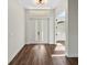 Bright entryway with double front doors, wood-look flooring, and modern light fixture at 4301 Marcella Ter, North Port, FL 34286
