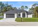 Beautifully landscaped modern home with a two-car garage and impact windows on a sunny day at 4301 Marcella Ter, North Port, FL 34286