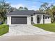 Exterior view of a modern single-story home with a paved driveway at 4301 Marcella Ter, North Port, FL 34286