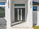 Modern front entry with double doors and paver walkway at 4301 Marcella Ter, North Port, FL 34286