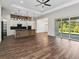 Open-concept kitchen and living area with wood-look flooring, modern island, and sliding glass doors at 4301 Marcella Ter, North Port, FL 34286