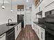 Sleek kitchen with black countertops, white cabinets, and stainless steel appliances at 4301 Marcella Ter, North Port, FL 34286